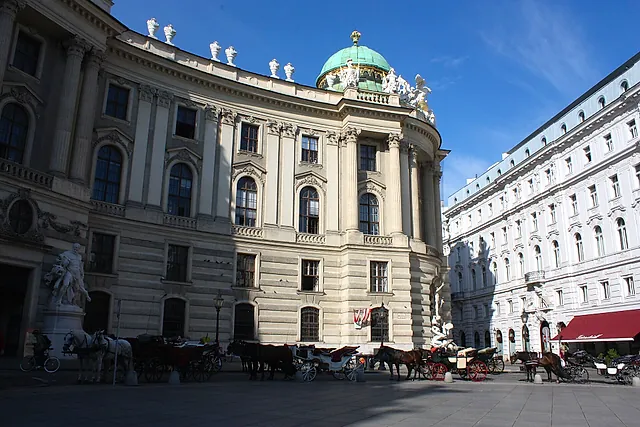 The Hofburg on Michaelerplatz in Vienna, with the dome and horse-drawn carriages