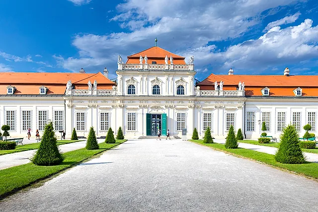 The Lower Belvedere at the end of a gravel path between cone-shaped trimmed shrubs