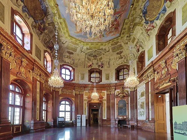The Marble Hall of the Upper Belvedere, with chandeliers and a frescoed ceiling